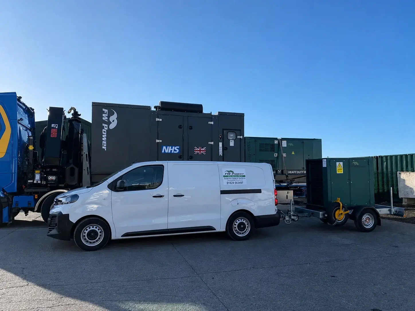 NHS-branded diesel generator with an FW Power service van and generator trailer